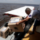 In the Amazon River, electoral workers use boats to move voting machines to voting stations.